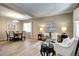 Inviting living room featuring hardwood floors, natural light, and a comfortable seating area next to the dining area at 7329 Arco Iris Ln, Castle Pines, CO 80108
