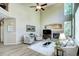 Bright living room with a fireplace, ceiling fan, and lots of natural light at 7329 Arco Iris Ln, Castle Pines, CO 80108