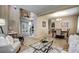 Spacious living room seamlessly connects to the dining area, highlighted by hardwood floors and an elegant staircase at 7329 Arco Iris Ln, Castle Pines, CO 80108