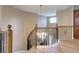 Elegant staircase with decorative iron railings leads to the upper level of this beautiful home at 7329 Arco Iris Ln, Castle Pines, CO 80108