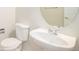 Clean bathroom with pedestal sink and oval mirror at 11729 Elmer Linn Dr, Longmont, CO 80504