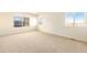 Bright bedroom with carpet flooring and two windows at 11729 Elmer Linn Dr, Longmont, CO 80504