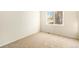 Bright bedroom with neutral carpeting and large window at 11729 Elmer Linn Dr, Longmont, CO 80504