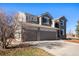 Two-story house with gray siding, stone accents, and a two-car garage at 11729 Elmer Linn Dr, Longmont, CO 80504