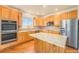 Spacious kitchen with island, stainless steel appliances, and wood cabinets at 11729 Elmer Linn Dr, Longmont, CO 80504