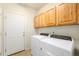 Laundry room with washer, dryer, and upper cabinets at 11729 Elmer Linn Dr, Longmont, CO 80504