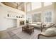 Living room with high ceilings, hardwood floors, and a fireplace at 11729 Elmer Linn Dr, Longmont, CO 80504