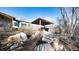Backyard featuring a pergola, stone patio, and lush landscaping, creating a private retreat at 8250 W 63Rd Ave, Arvada, CO 80004