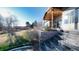 Inviting backyard with a covered porch, stone retaining wall, and lush lawn, perfect for outdoor gatherings at 8250 W 63Rd Ave, Arvada, CO 80004