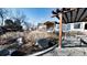 Landscaped backyard with wooden pergola and mature trees at 8250 W 63Rd Ave, Arvada, CO 80004