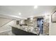 Unique basement bar design with stone accents and an eye-catching countertop at 8250 W 63Rd Ave, Arvada, CO 80004