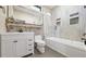 Modern bathroom with a combined bathtub and shower, vanity, and stylish tile at 8250 W 63Rd Ave, Arvada, CO 80004