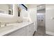 Bathroom featuring double vanity, quartz countertop and shower at 8250 W 63Rd Ave, Arvada, CO 80004