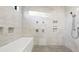 Bathroom featuring a tiled shower and soaking tub at 8250 W 63Rd Ave, Arvada, CO 80004