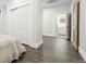 Primary bedroom with ensuite bathroom, and a closet with sliding doors, and wood-look tile flooring at 8250 W 63Rd Ave, Arvada, CO 80004