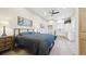 Modern bedroom with light wood floors, ceiling fan, artwork and kitchenette area at 8250 W 63Rd Ave, Arvada, CO 80004