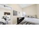 Cozy bedroom with a comfortable bed, neutral walls, and an open doorway to the living room at 8250 W 63Rd Ave, Arvada, CO 80004