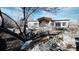 A charming house with a rustic exterior, stone accents, and mature trees, creating a serene setting at 8250 W 63Rd Ave, Arvada, CO 80004