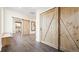 Hallway featuring barn doors, stylish wood-look tile flooring, and natural light at 8250 W 63Rd Ave, Arvada, CO 80004