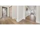 Bright hallway with wood floors and natural light pouring in from a window at the end at 8250 W 63Rd Ave, Arvada, CO 80004