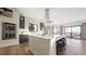 Open-concept kitchen featuring a large island with bar seating, modern appliances, and hardwood floors at 8250 W 63Rd Ave, Arvada, CO 80004
