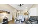 Open-concept living room with hardwood floors, neutral decor, and seamless flow to the kitchen at 8250 W 63Rd Ave, Arvada, CO 80004