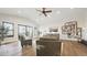Large living room with a wall of windows and hardwood flooring at 8250 W 63Rd Ave, Arvada, CO 80004