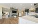 Bright and open living room with a fireplace and hardwood floors, part of an open-concept design at 8250 W 63Rd Ave, Arvada, CO 80004