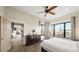 Bedroom featuring a dresser, large windows, ceiling fan and hardwood floors at 8250 W 63Rd Ave, Arvada, CO 80004