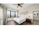Cozy bedroom with a large window, ceiling fan, and hardwood floors at 8250 W 63Rd Ave, Arvada, CO 80004