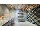 Finished basement with a wine cellar and shelving at 8250 W 63Rd Ave, Arvada, CO 80004