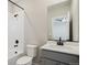 Modern bathroom featuring a shower-tub combo, stylish vanity, and matte black fixtures at 9462 Yampa Ct, Commerce City, CO 80022