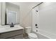 Bathroom featuring a shower-tub combo, stylish vanity, and matte black fixtures at 9462 Yampa Ct, Commerce City, CO 80022