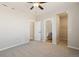 Bedroom showcasing neutral carpet, a ceiling fan, and ensuite bathroom and walk-in closet at 9462 Yampa Ct, Commerce City, CO 80022