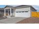Charming home exterior highlighting a two-car garage, covered porch, and well-maintained landscaping at 9462 Yampa Ct, Commerce City, CO 80022