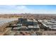 Aerial view of the building complex featuring city skyline and a nearby lake at 4200 W 17Th Ave # 912, Denver, CO 80204