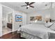 Cozy bedroom with hardwood floors, a ceiling fan, and access to the ensuite bathroom at 4200 W 17Th Ave # 912, Denver, CO 80204