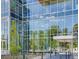 Modern building exterior with glass facade and views reflecting sky and surrounding greenery at 4200 W 17Th Ave # 912, Denver, CO 80204