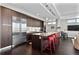 Modern kitchen featuring stainless steel appliances, granite countertops, a spacious island and stylish red bar stools at 4200 W 17Th Ave # 912, Denver, CO 80204