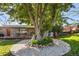 Backyard includes a deck with dining, mature trees, water feature, and a peaceful outdoor living space at 760 Deframe St, Golden, CO 80401