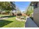 Manicured backyard features lush green lawn, garden area, bird bath, mature trees, and privacy fence at 760 Deframe St, Golden, CO 80401