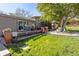 Extensive backyard view with a wood deck, well-maintained lawn, a stone garden, and mature trees for privacy at 760 Deframe St, Golden, CO 80401