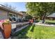 Picturesque backyard with a wood deck, manicured lawn, a stone garden, and mature trees providing ample shade at 760 Deframe St, Golden, CO 80401