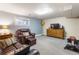 Finished basement featuring a comfortable seating area, a TV, and functional workout equipment at 760 Deframe St, Golden, CO 80401
