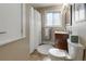 Well-lit bathroom featuring a modern vanity, updated fixtures, and shower with white curtain at 760 Deframe St, Golden, CO 80401
