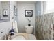 Stylish half bathroom with a decorative mirror, blue accents, and attractive tile work at 760 Deframe St, Golden, CO 80401