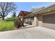 Brick home with a pergola-covered seating area, landscaping and concrete driveway at 760 Deframe St, Golden, CO 80401