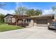 Brick exterior home with a pergola covered porch and a well-maintained lawn and driveway at 760 Deframe St, Golden, CO 80401