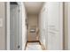 Hallway featuring hardwood floors, white trim, and convenient built-in storage cabinets at 760 Deframe St, Golden, CO 80401