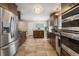 Updated kitchen with stainless steel appliances, stone countertops, and tile floors at 760 Deframe St, Golden, CO 80401